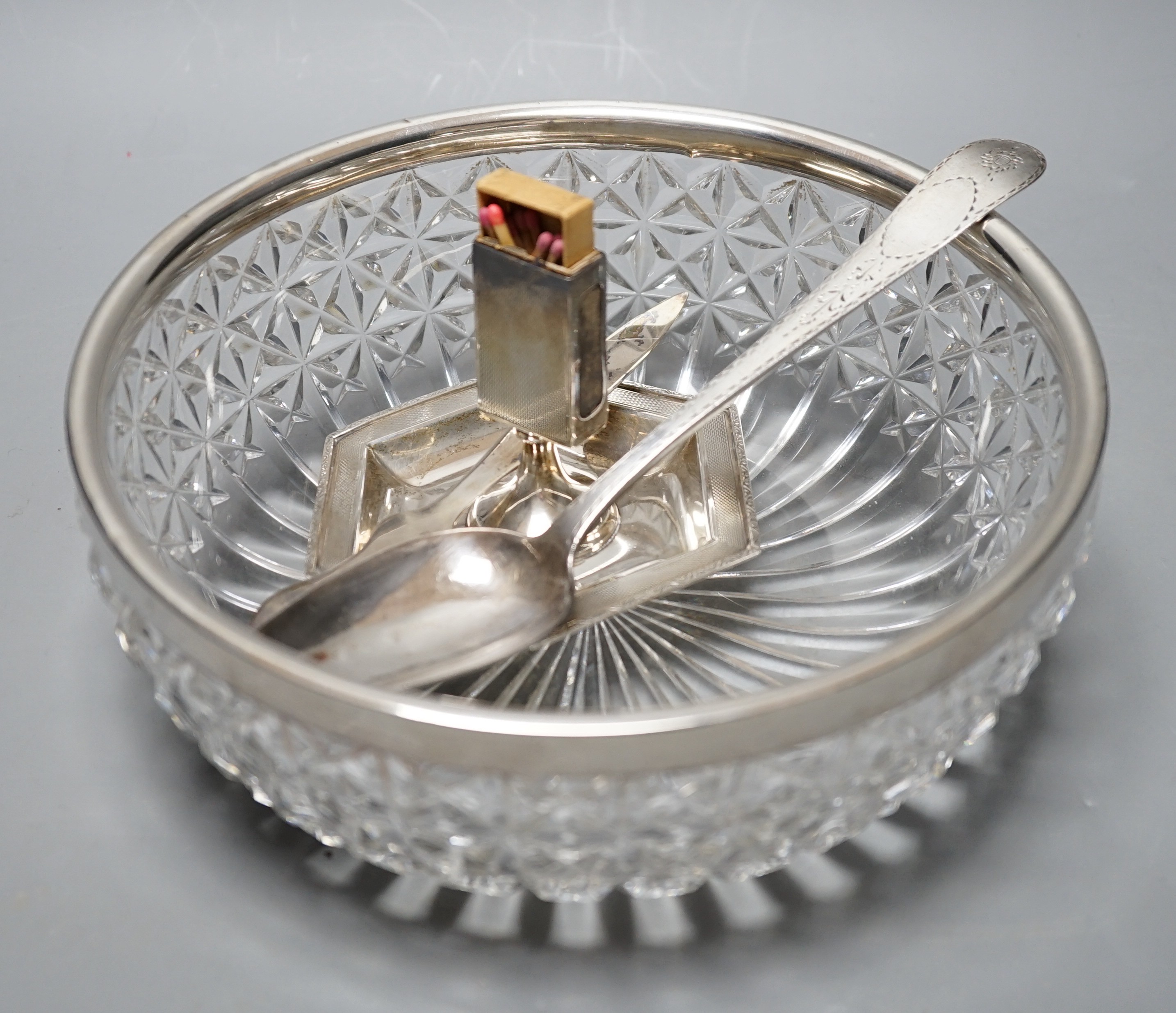 A George III Irish bright cut engraved silver tablespoon, Dublin, 1798, a silver match sleeve/ashtray, a silver rimmed fruit bowl fruit bowl and 925 letter opener.